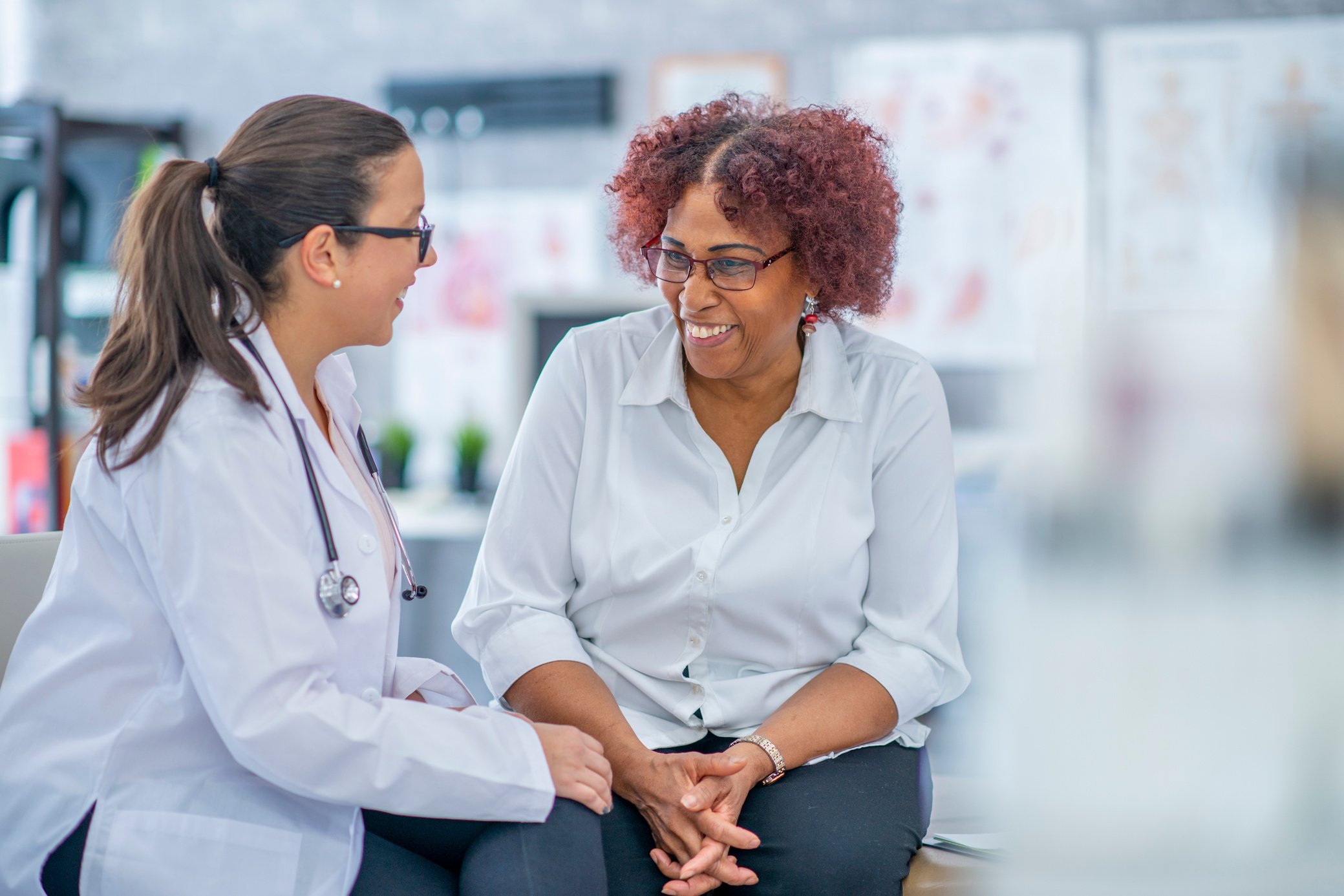 Patient and doctor smiling